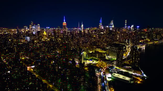 Amazing view of New York at dusk. Approaching spectacular skyscrapers with neon illumination. Top view. photo