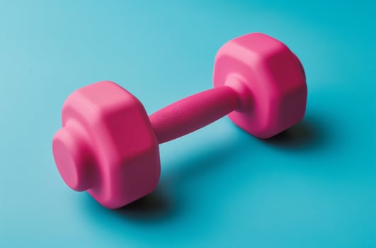 Pink dumbbell blue background photo