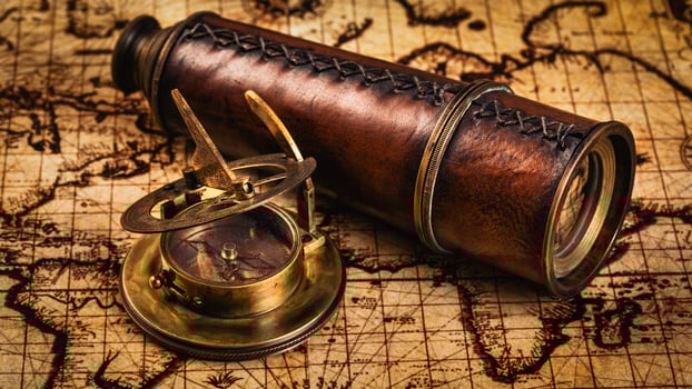 Old vintage compass on ancient map photo