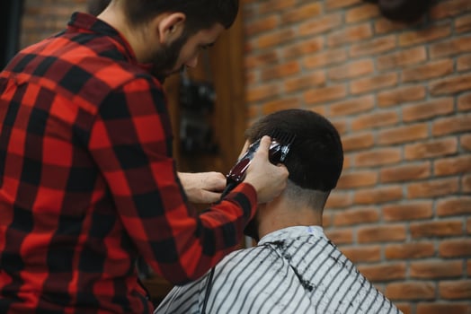 Men's haircut at the barber scissors. photo