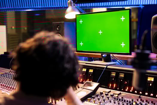 Artists recording and editing music to produce a new album in control room professional studio, working together to do mix and master on music. Team of musicians creating new tracks. photo