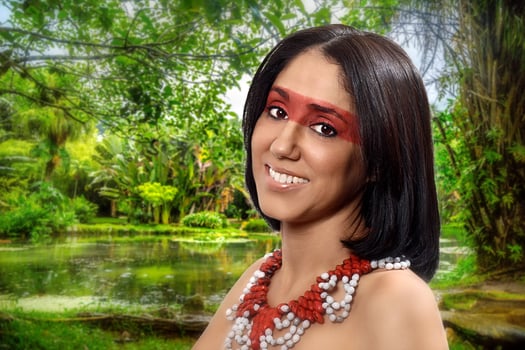 smiling brunette model in Brazilian Indian costume and makeup holding a tapioca, a typical Brazilian snack photo