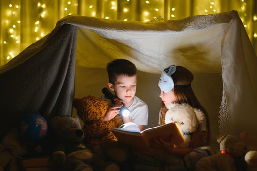 Little children reading bedtime story at home photo