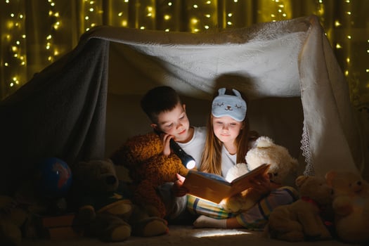 Little children reading bedtime story at home photo