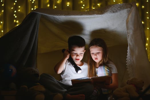 Little children reading bedtime story at home photo