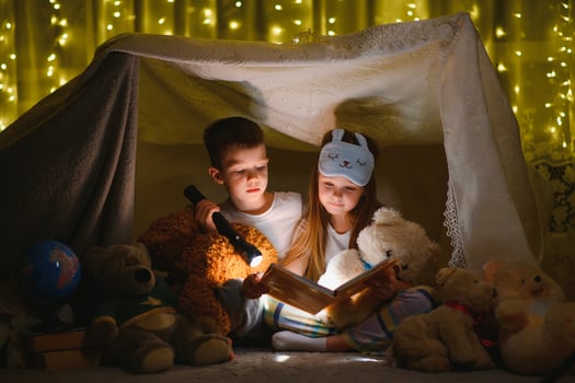 Little children reading bedtime story at home photo