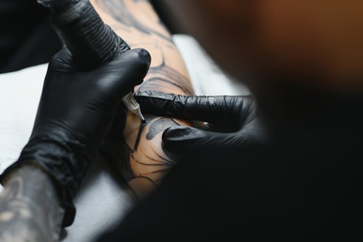 Professional tattoo artist working in his tattoo studio. photo