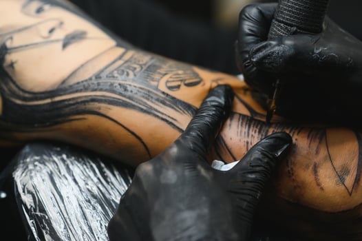 Professional tattoo artist working in his tattoo studio. photo
