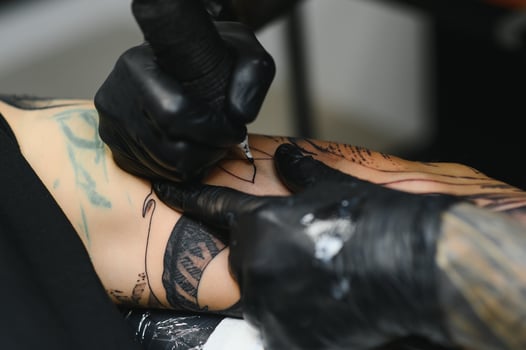 Professional tattoo artist working in his tattoo studio. photo