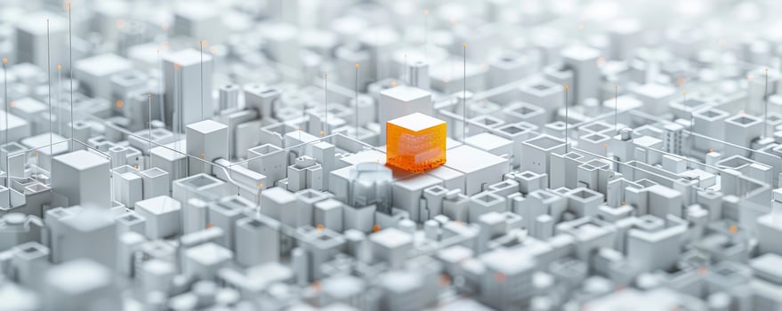 An orange cube is in the middle of a city photo