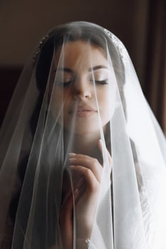 A woman is wearing a veil and looking at the camera photo