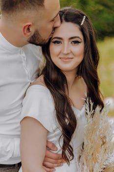 A man and woman are kissing each other photo