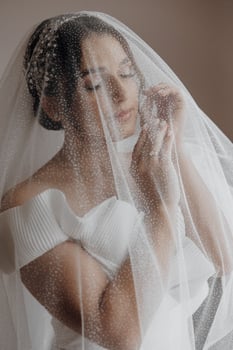 A woman is wearing a veil with a lot of sparkles on it photo