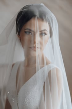 A woman is wearing a veil and smiling photo