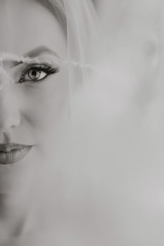 A woman's face is shown in a black and white photo, with her eyes closed photo