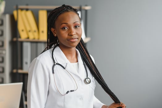 Portrait Of Smiling Female Doctor Wearing White Coat With Stethoscope In Hospital Office. photo