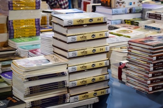 New Delhi, India, February 17 2024 - Variety of Books on shelf inside a book-stall at Delhi International Book Fair, Selection of books on display in Annual Book Fair at Bharat Mandapam complex photo