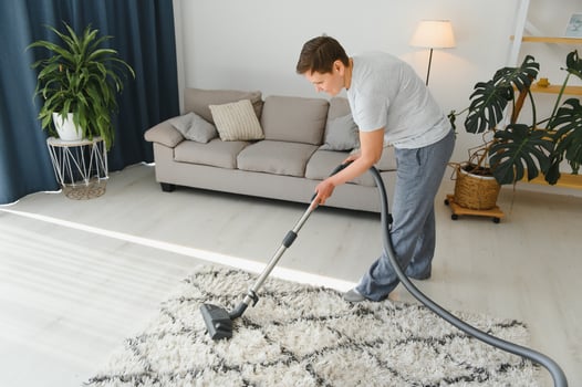 Cleaning concept. woman cleaning carpet with vacuum cleaner. photo