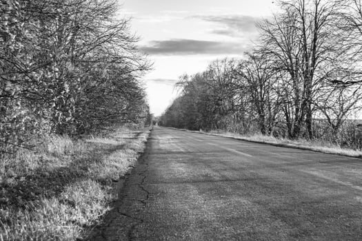 Beautiful empty asphalt road in countryside on colored background photo