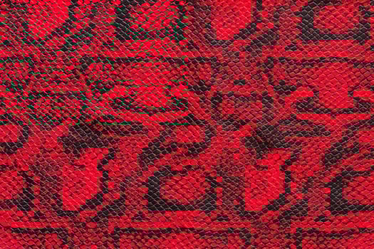 Texture of synthetic red snake skin photo