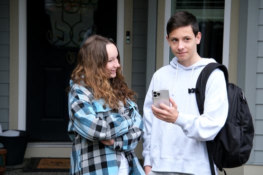 do homework together peep boy and girl sit next in tracksuits and plaid girl smiles turns boy helps finds mistakes straightens hair desire likes help friend School years Classmates teenagers photo