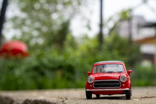 A close-up picture of a retro red toy car photo