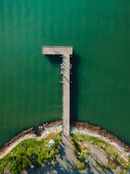 Top view of pier and sea with sunlight, aerial view photo