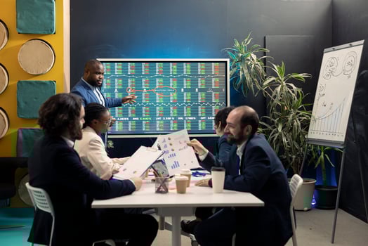 Team of business employees study feedback on old initiatives to improve their work for the future, developing new strategies in coworking space conference room. Marketing organization activity. photo