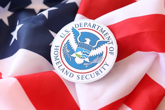 KYIV, UKRAINE - MARCH 9, 2024 US Department of Homeland Security seal on United States of America flag photo