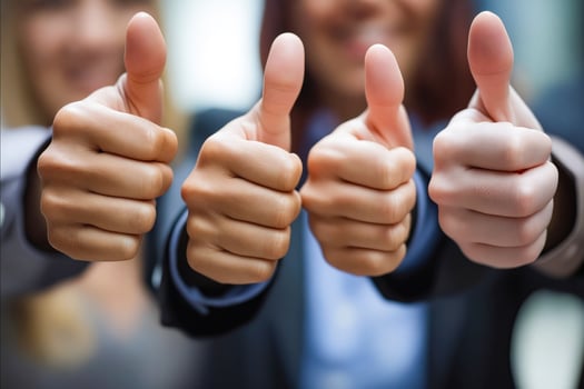 A group of people are giving thumbs up to each other photo