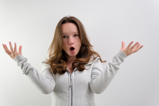 Surprised Young Woman Wondering on White Background photo