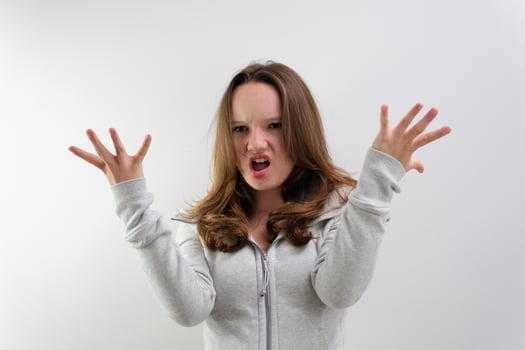 negative emotion of adolescence brain explosion girl with her hands shows how it explodes in her head experiences opens mouth waves hands boom strong explosion on a white background emotional teenager photo