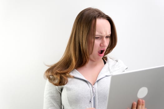 Screaming woman looking at laptop screen photo