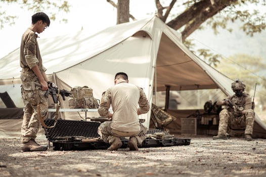 Soldiers in camouflage uniforms planning on operation in the camp photo