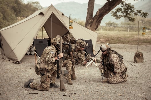 Soldiers in camouflage uniforms planning on operation in the camp photo