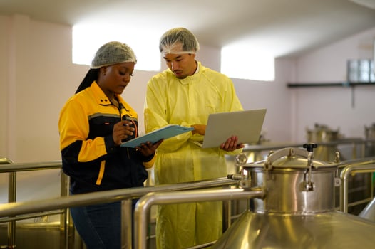 Professional winemaker controlling wine making process and quality at winery factory photo