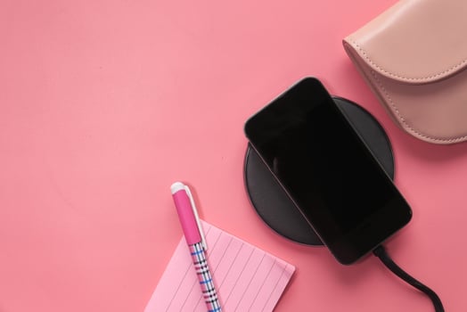 charging Smartphone Using Wireless Charging Pad, top view photo