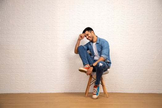 Stylish Man Is Posing While Sitting On Chair photo