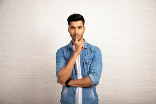 Brunette Male Model With Finger On Lips photo