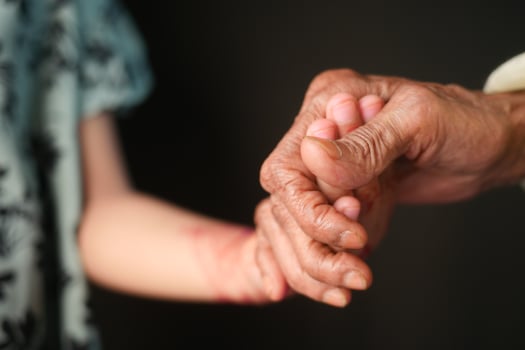 little girl holding hand of her grandmother hand photo