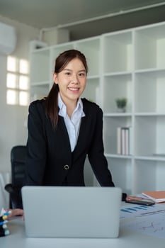 Young successful employee or business woman at desk at office. Achievement career concept photo