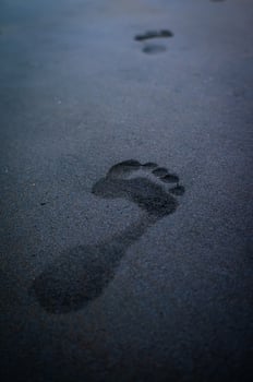 soles of feet, footprints on the beach sand photo