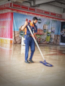 Jakarta, Indonesia on July 7 2022. A cleaner at Halim Perdanakusuma Airport. This officer is cleaning the airport floor so that it is clean and not slippery. photo