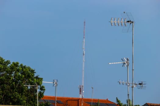 Television antennas that are mounted on the roof of the house photo