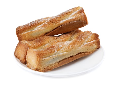 Several delicious crispy cookies lying on a white plate isolated on a white background. photo