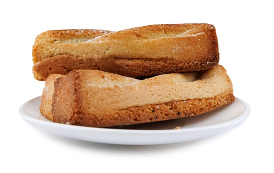 Several delicious crispy cookies lying on a white plate isolated on a white background. photo