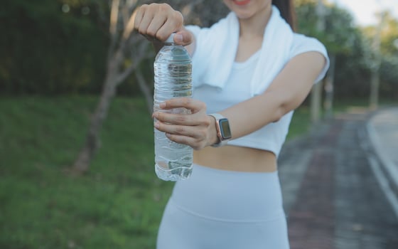 Young woman drinking protein shake outdoors photo