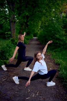 mother and daughter do sports and play in the park photo