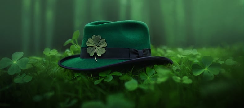 st patrick's day, green hat with shamrock in grass and clover on forest background photo