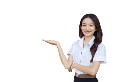 Portrait of an adult Thai student in university student uniform. Asian cute girl standing to present something confidently while isolated white background. photo